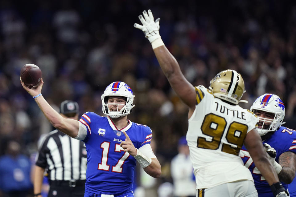 Buffalo Bills quarterback Josh Allen (17) passes under pressure from New Orleans Saints defensive tackle Shy Tuttle (99) in the second half of an NFL football game in New Orleans, Thursday, Nov. 25, 2021. (AP Photo/Derick Hingle)