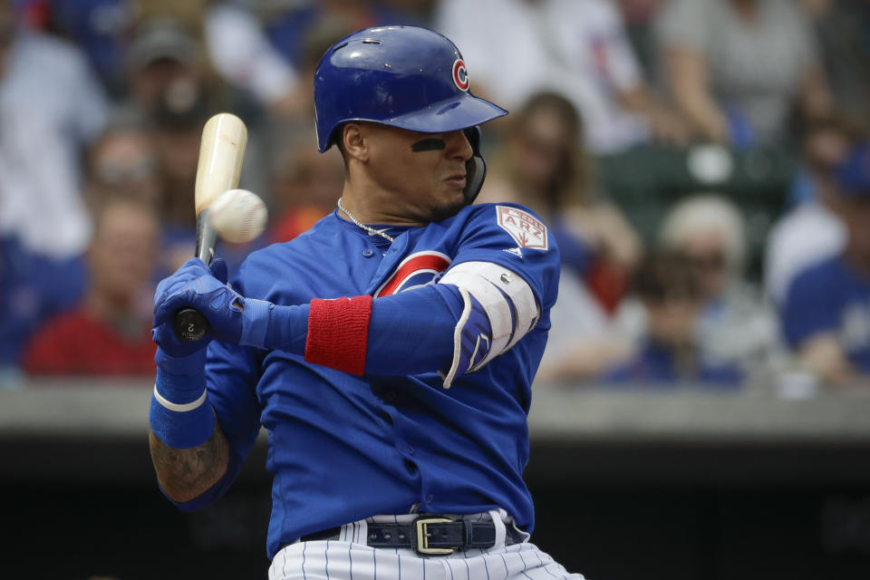 Chicago Cubs' Javier Baez gets out of the way of a pitch during the second inning of a spring baseball game against the Milwaukee Brewers in Mesa, Ariz., Saturday, March 2, 2019. (AP Photo/Chris Carlson)