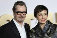 Actors Gary Oldman and Kristin Scott Thomas poses for photographs as they arrive at the UK premiere of Darkest Hour in London, Britain December 11, 2017. REUTERS/Simon Dawson