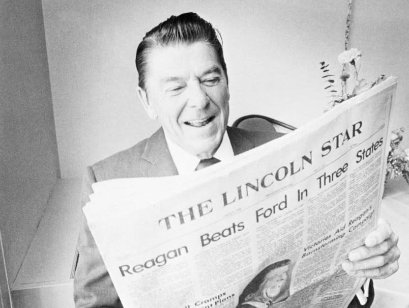 (Original Caption) Lincoln, Nebraska: Ronald Reagan is all smiles as he reads details of his sweep of Presidential Primaries in Indiana, Alabama and Georgia. Reagan spoke here to target delegates in preparation for Nebraska primary.