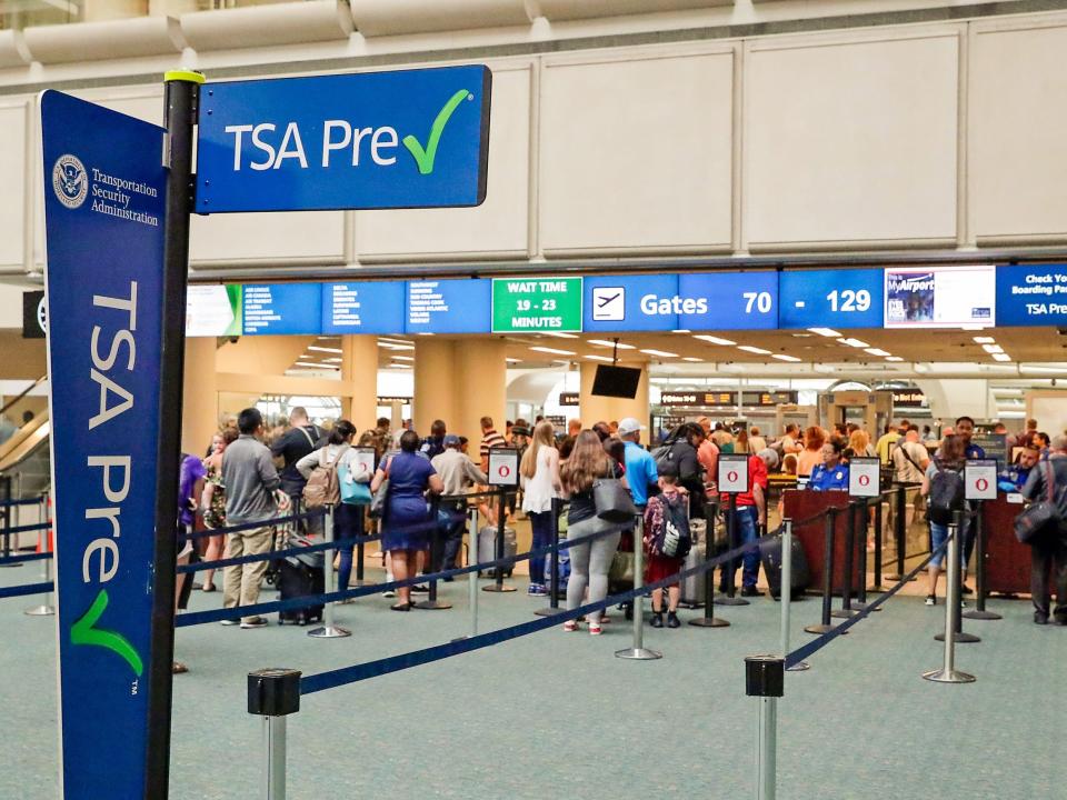 passengers heading to their departure gates enter TSA pre-check before going through security screening at Orlando International Airport,