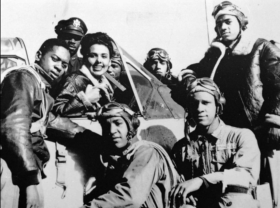In this January 1, 1945 photo, Lena Horne visits with the Tuskegee Airmen.