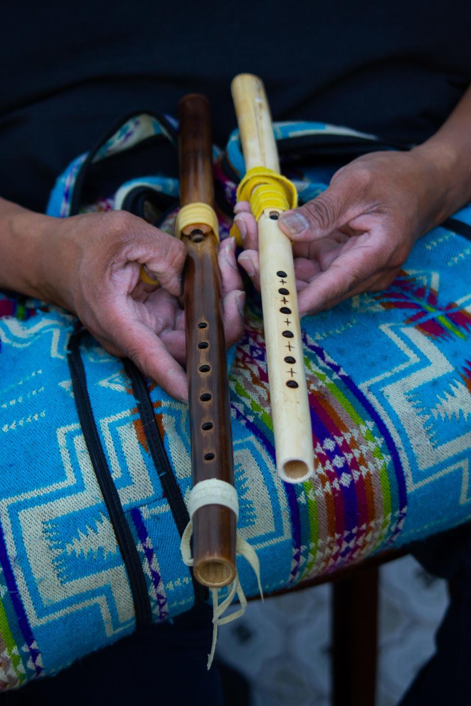 Aaron White burns the Arundo flute, so it changes its color to dark brown. The flute on the right keeps its original color.