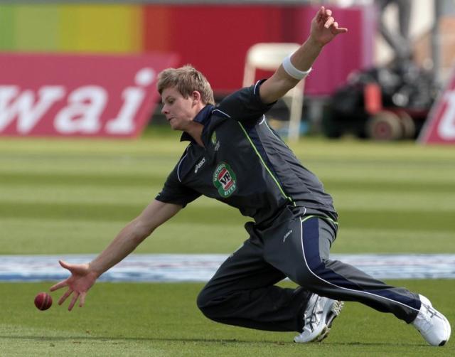 England cricket players look on during a training session, two