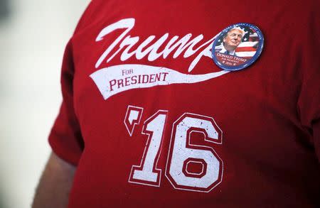 A supporter of Republican U.S. presidential candidate Donald Trump wearing a "Trump for President '16" t-shirt listens to the candidate speak at a campaign rally at the airport in Hagerstown, Maryland, U.S. On April 24, 2016. REUTERS/Jim Bourg/File Photo