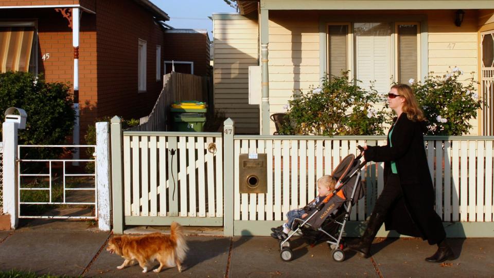 Woman walking with pram and dog