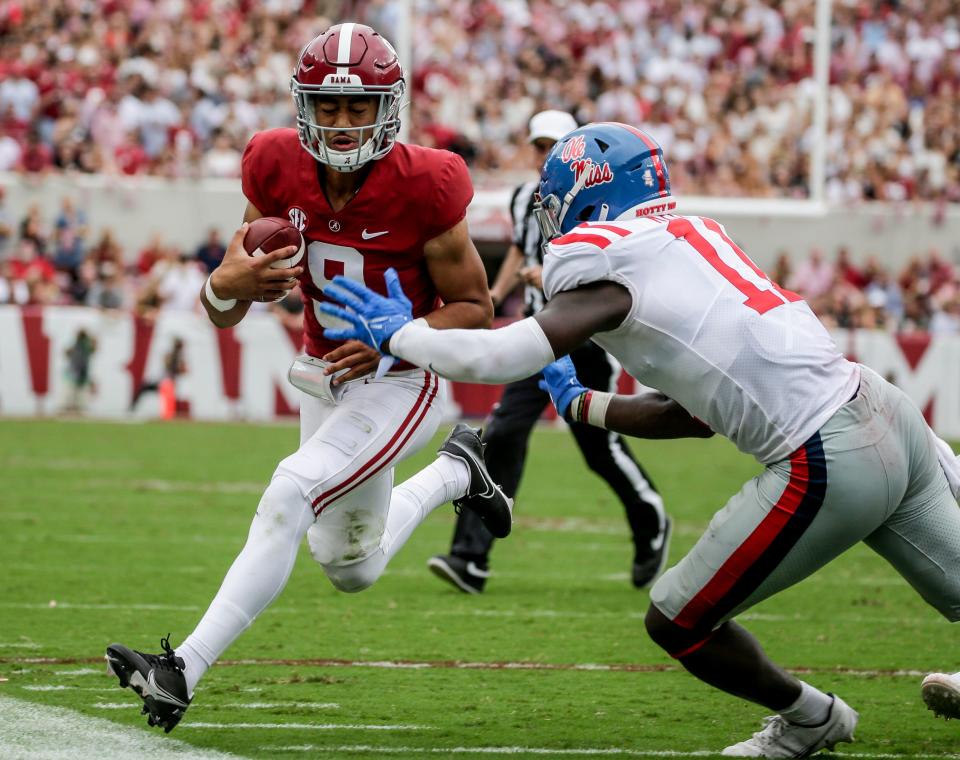 Alabama quarterback Bryce Young (9) is pushed out of bounds by Mississippi linebacker Austin Keys (11) during the second half of their 2021 game at Bryant-Denny Stadium.