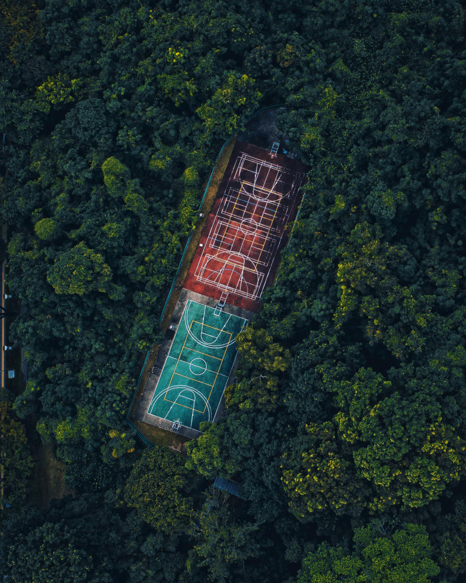 'Hoops in the woods' by @i.ride.to.drone shows basketball courts in the middle of the forest in the city-state  of Singapore.