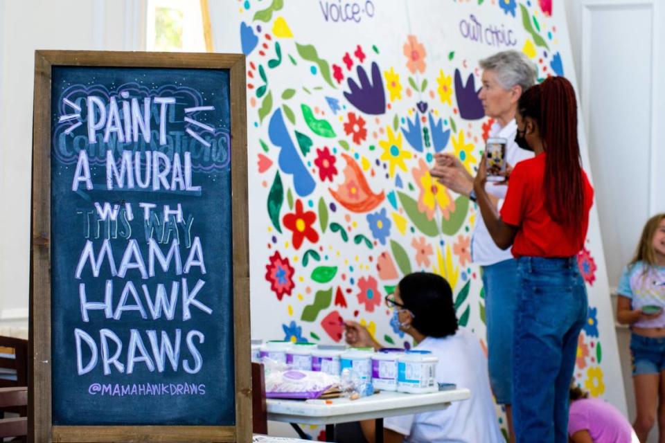 Visitors help paint a mural at Wesleyan College Sept. 17 during a community reproductive rights painting event with artist Erin Hawkins “Mama Hawk Draws”. Wesleyan will unveil the completed mural during a Rep the Rights Rally on Friday, Sept. 30.