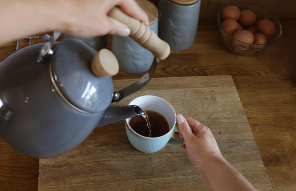 A person is making themselves a cup of tea