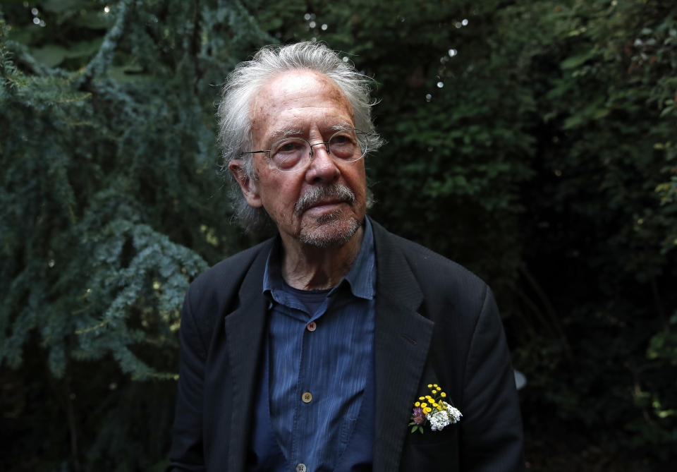 FILE - In this Thursday, Oct. 10, 2019 file photo, Austrian author Peter Handke poses for a photo at his house in Chaville near Paris. Several dozen survivors of Bosnia’s 1992-95 war staged a protest in Sarajevo to call on the Nobel Committee to reverse its decision to award the 2019 Nobel Prize in literature to Austria’s Peter Handke. Protesters gathered outside the Swedish embassy in downtown Sarajevo Tuesday carrying banners with slogans comparing Handke with Serbian strongman Slobodan Milosevic and Bosnian Serb war-time leaders Radovan Karadzic and Ratko Mladic. (AP Photo/Francois Mori, file)