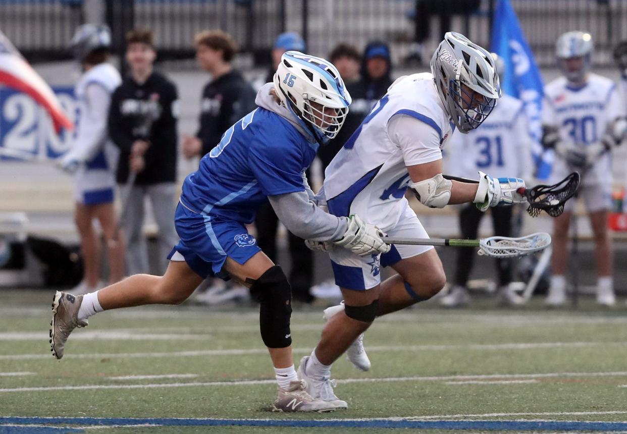 Liberty senior Freddy Noday (right) battles Berlin junior midfielder Zach Patton. Noday was Region 1 Player of the Year as a faceoff specialist and first-team all-league. He won 72.5% of his draws and led the Patriots with 130 ground balls.