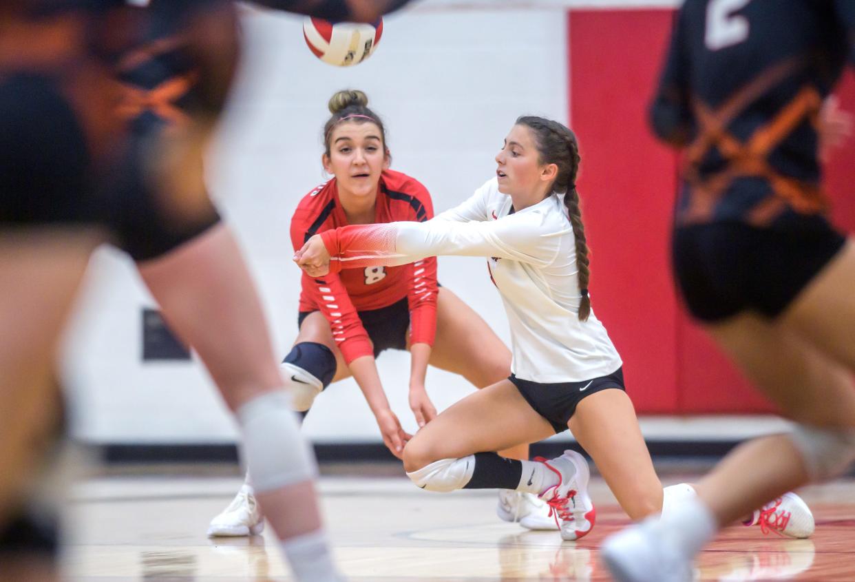 Metamora's Ryan Schwarz, in white, bumps the ball in front of teammate Esma Frieden in the first set of their volleyball match against Washington on Tuesday, Sept. 5, 2023 in Metamora. The Redbirds downed the Panthers in straight sets.