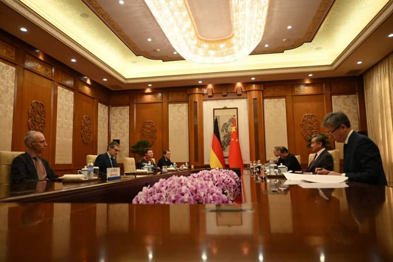 Jens Ploetner (2nd-L), Advisor to the German Chancellor for Foreign and Security Policy, sits in front of Wang Yi (2-R), China's Foreign Minister. German diplomats met with Chinese politicians in Beijing on 23 February to discuss various bilateral and global political issues. Johannes Neudecker/dpa