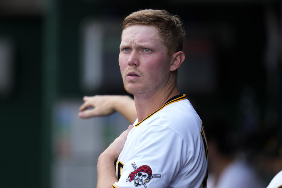 Pittsburgh Pirates starter Mitch Keller stretches in the dugout after pitching in the first inning of the team's baseball game against the Cincinnati Reds in Pittsburgh, Friday, April 21, 2023. (AP Photo/Gene J. Puskar)