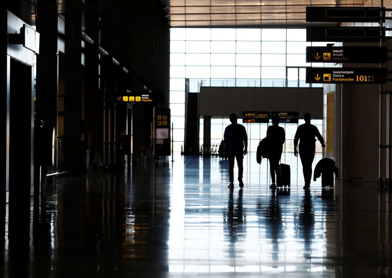 British tourists walk while leaving the airport after arriving from London, amid the spread of the coronavirus disease (COVID-19) In Telde