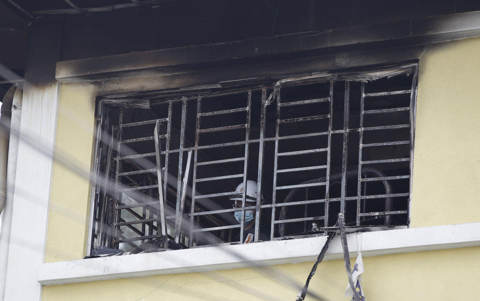 <p>Forensic police officer investigates burnt windows at an Islamic religious school following a fire on the outskirts of Kuala Lumpur Thursday, Sept. 14, 2017. (Photo: Daniel Chan/AP) </p>