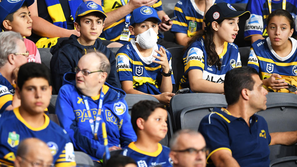 A young spectator, pictured here wearing a face mask while looking on during the Parramatta Eels and Canterbury Bulldogs clash.