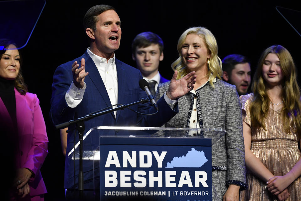 CORRECTS SPELLING OF FIRST NAME TO BRITAINY NOT BRITIANY - Kentucky Gov. Andy Beshear speaks during an election night rally after he was elected to a second term in Louisville, Ky., Tuesday, Nov. 7, 2023. At right is his wife Britainy Beshear. (AP Photo/Timothy D. Easley)