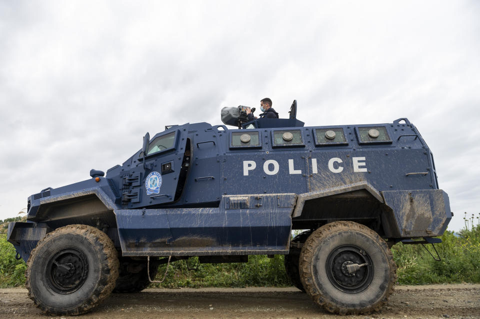 Police officer Dimitris Bistinas operates a long range acoustic device, (LRAD), attached on a police vehicle, during a patrol alongside the Greek - Turkish border near the town of Feres, Greece, Friday, May 21, 2021. An automated hi-tech surveillance network being built on the Greek-Turkish border aiming at detecting migrants early and deterring them from crossing, with river and land patrols using searchlights and long-range acoustic devices. (AP Photo/Giannis Papanikos)