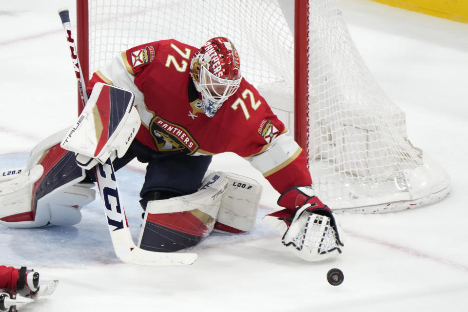 Florida Panthers goaltender Sergei Bobrovsky reaches for the puck to make a save during the third period of an NHL hockey game against the San Jose Sharks, Thursday, Feb. 9, 2023, in Sunrise, Fla. (AP Photo/Wilfredo Lee)