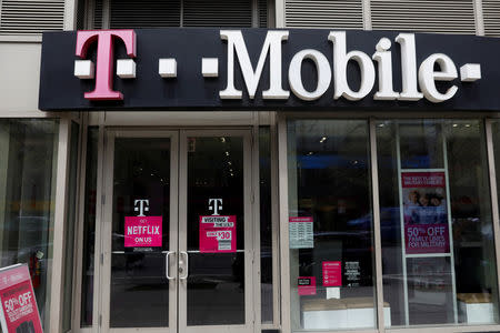 FILE PHOTO: A sign for a T-Mobile store is seen in Manhattan, New York, U.S., April 30, 2018. REUTERS/Shannon Stapleton