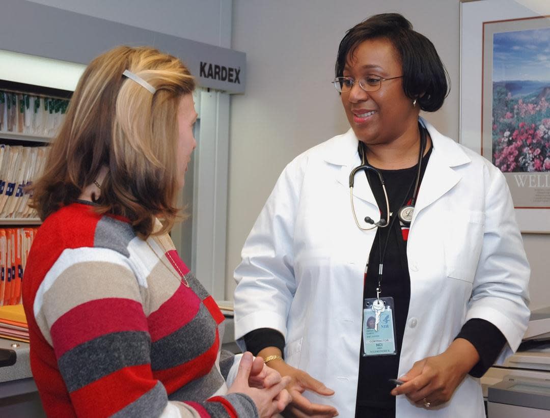 A woman speaking with her doctor. Physical exams. 