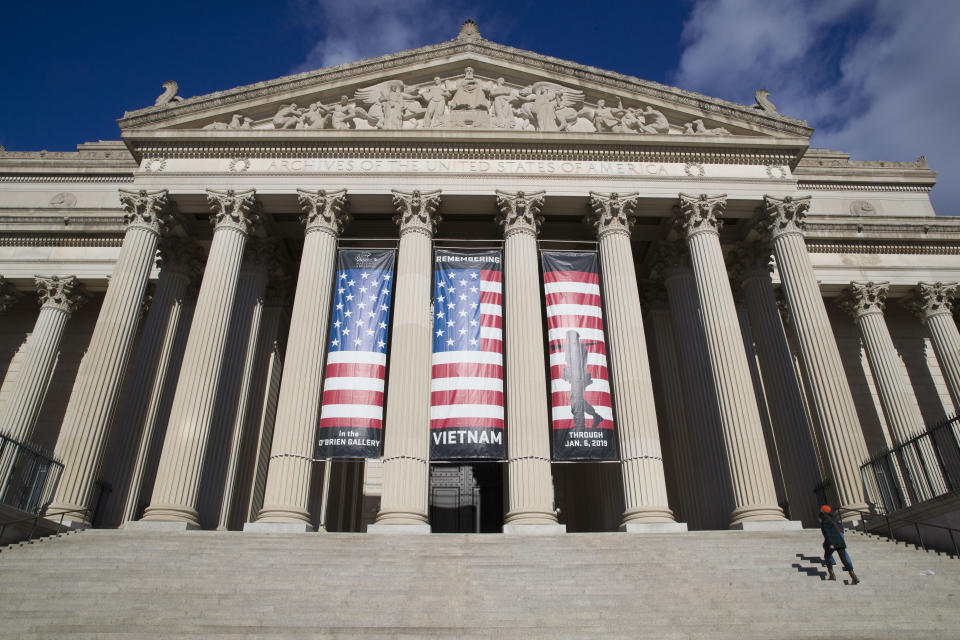 FILE - People walk up the steps even though the National Archives is closed with the partial government shutdown Dec. 22, 2018, in Washington. Colleen Shogan, the new Archivist of the United States whose appointment became entangled in the partisan furor over a criminal case against former President Donald Trump, is preparing the National Archives for a coming flood of digital documents while acknowledging that it needs more money and staff to do a preservation job that only grows each year. (AP Photo/Alex Brandon, File)