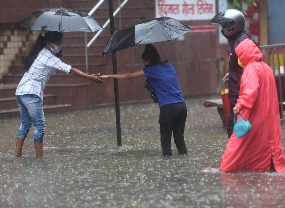 MUMBAI, INDIA - JULY 16: People cross the waterlogged street during heavy rain at Hindmata, Parel, on July 16, 2020 in Mumbai, India. (Photo by Satish Bate/Hindustan Times via Getty Images)