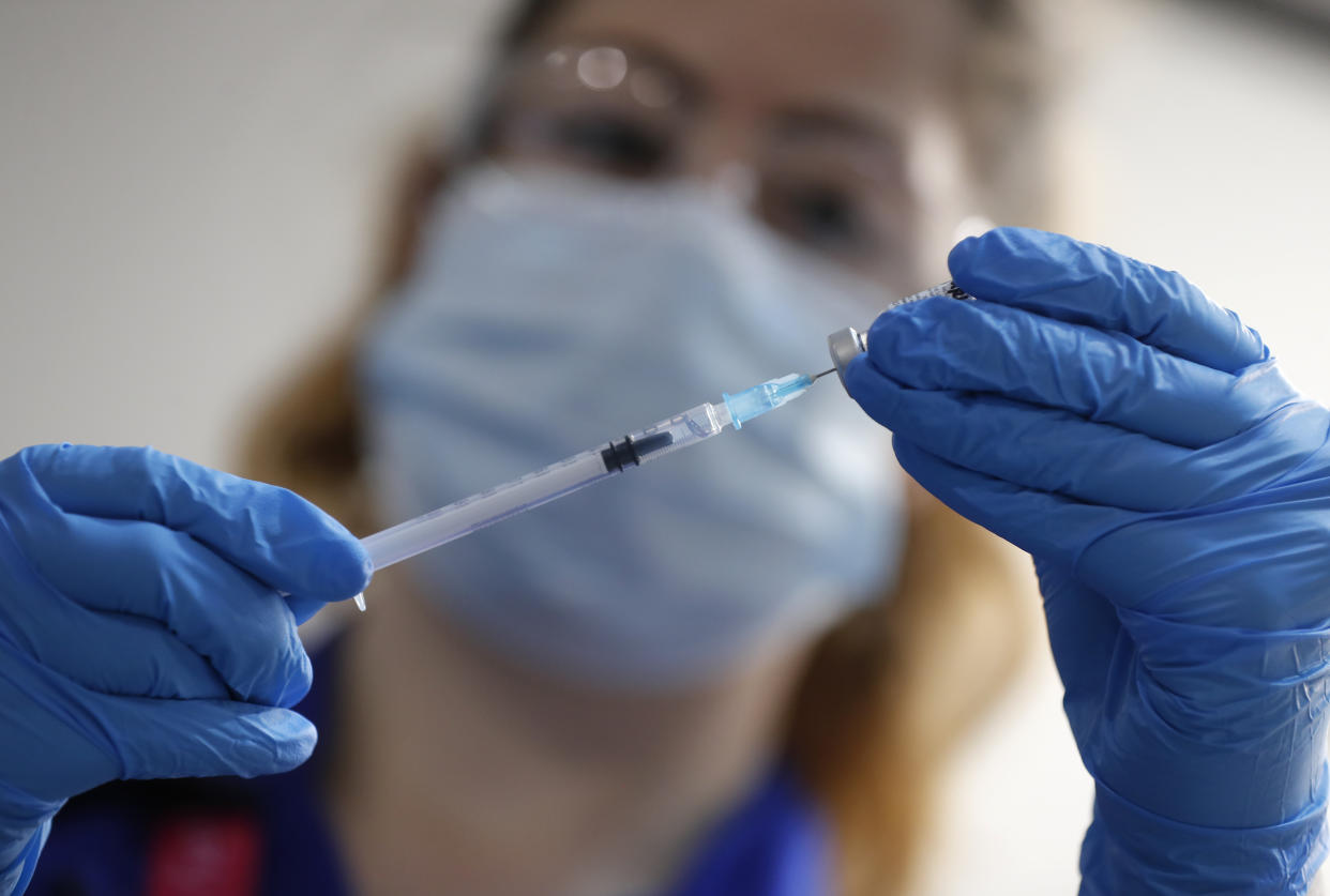 A nurse prepares to administer the Pfizer-BioNTech COVID-19 vaccine at Guy&#39;s Hospital in London, Tuesday, Dec. 8, 2020. U.K. health authorities rolled out the first doses of a widely tested and independently reviewed COVID-19 vaccine Tuesday, starting a global immunization program that is expected to gain momentum as more serums win approval. (AP Photo/Frank Augstein, Pool)