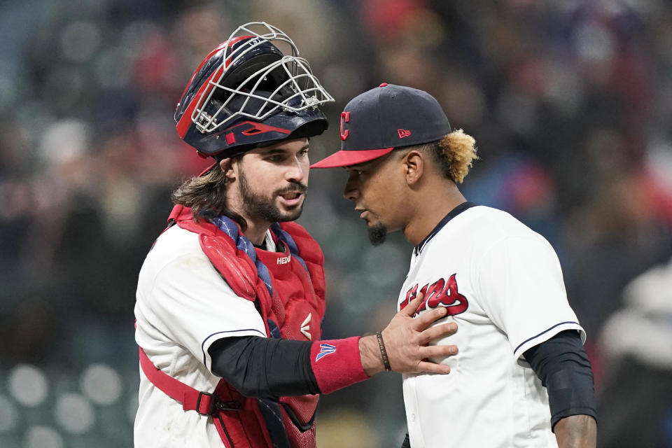 Cleveland Indians catcher Austin Hedges, left, congratulates relief pitcher Emmanuel Clase after the Indians defeated the Chicago Cubs 3-2 in a baseball game, Tuesday, May 11, 2021, in Cleveland. (AP Photo/Tony Dejak)