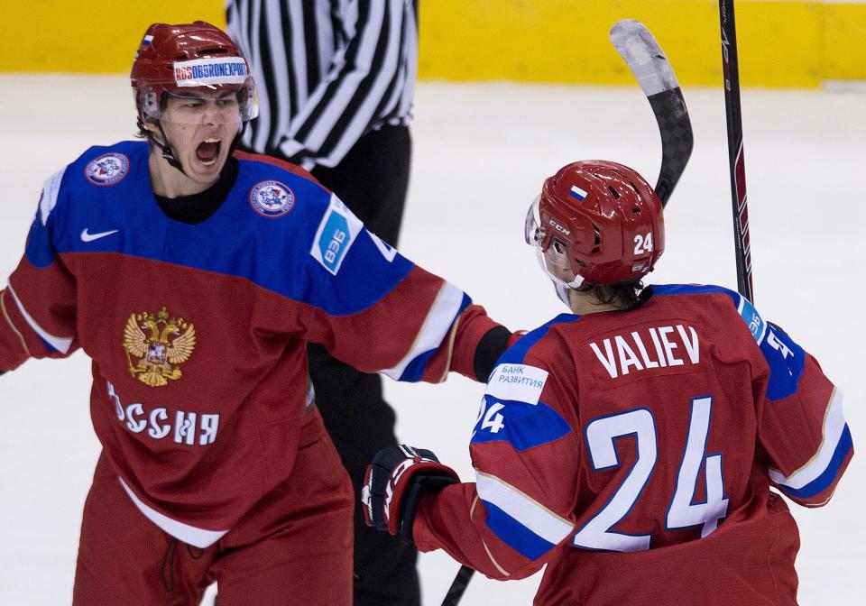 Russia defenceman Ziyat Paigin, left, reacts with teammate Rinat Valiev (24) after scoring past Sweden during second-period semifinal hockey action at the world junior championships in Toronto, Sunday, Jan. 4, 2015. (AP Photo/The Canadian Press, Nathan Denette)