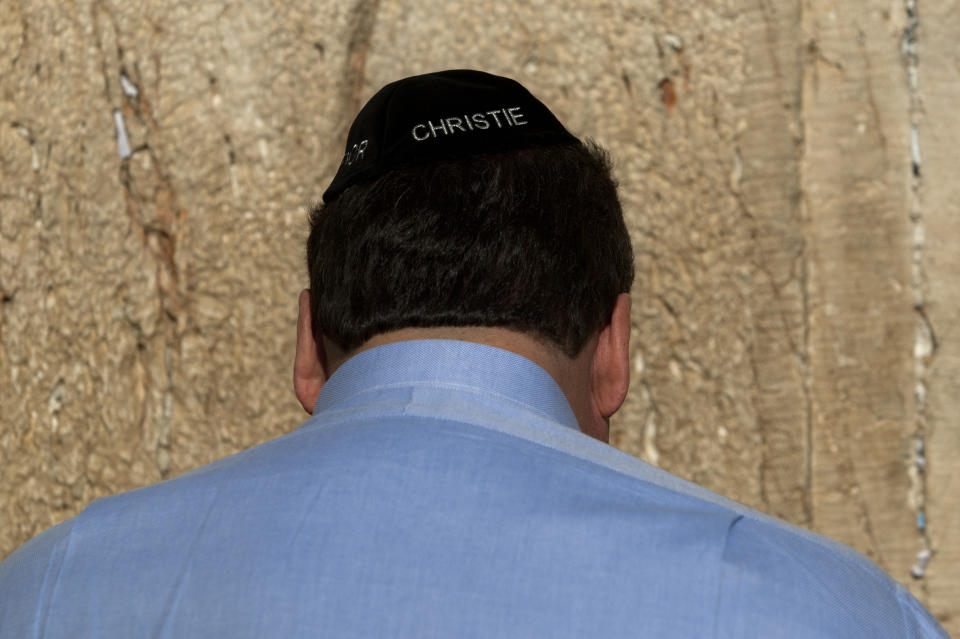 New Jersey Gov. Chris Christie touches the stones of the Western Wall, the holiest site where Jews can pray, during his visit to Jerusalem's old city, Monday, April 2, 2012. Christie kicked off his first official overseas trip Monday meeting Israel's leader in a visit that may boost the rising Republican star's foreign policy credentials ahead of November's presidential election. (AP Photo/Sebastian Scheiner)
