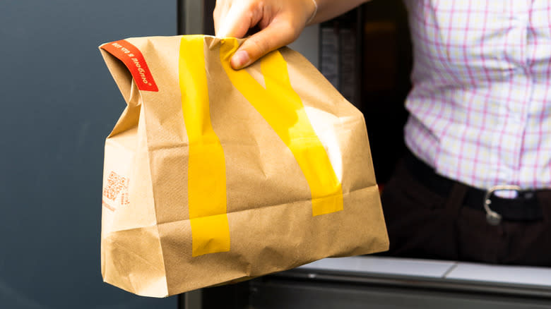 McDonald's employee handing over bag