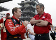 File - Al Unser Jr., left, talks with his father Al Unser Sr., before the start of qualifications at the Indianapolis Motor Speedway Saturday, May 10, 2003. Al Unser, one of only four drivers to win the Indianapolis 500 a record four times, died Thursday, Dec. 9, 2021, following years of health issues. He was 82. (AP Photo/Tom Strattman, File)