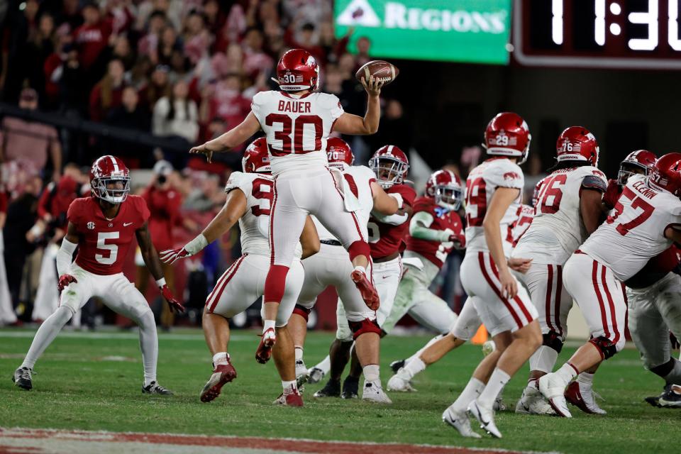 Nov 20, 2021; Tuscaloosa, Alabama, USA; Arkansas Razorbacks punter Reid Bauer (30) throws a pass for a touchdown on a fake field goal against the Alabama Crimson Tide during the second half at Bryant-Denny Stadium. Mandatory Credit: Butch Dill-USA TODAY Sports