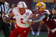 Minnesota defensive lineman Esezi Otomewo (9) drags Nebraska quarterback Adrian Martinez (2) into the end zone where he intentionally grounded the ball resulting in a safety in the fourth quarter of an NCAA college football game Saturday, Oct. 16, 2021, in Minneapolis. Minnesota won 30-23. (AP Photo/Bruce Kluckhohn)