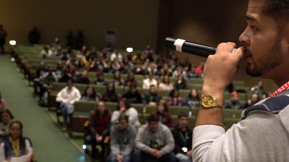 Angel Diaz is seen addressing the audience at STEAM the Streets' "This Can Be You" Career Awareness Show for ninth grade students at Greater New Bedford Regional Vocational Technical High School on Jan. 16, 2020.
