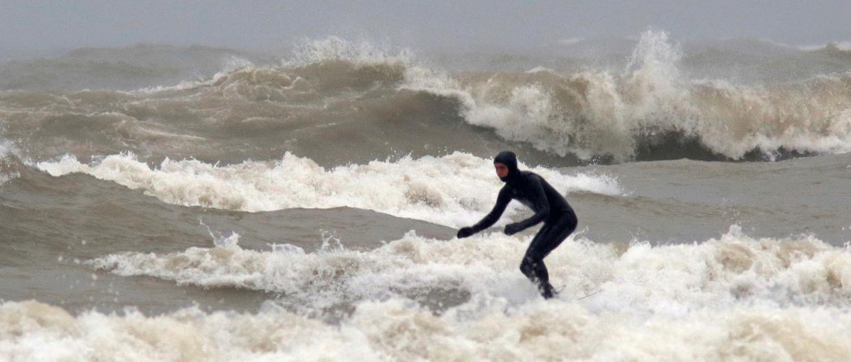 A surfer takes on the waves at Deland Park, Monday, January 7, 2019, in Sheboygan, Wis. Westerly winds of 15-25 knots were expected to be in the 3 to 8 foot range with possibilities as high as 10 feet.