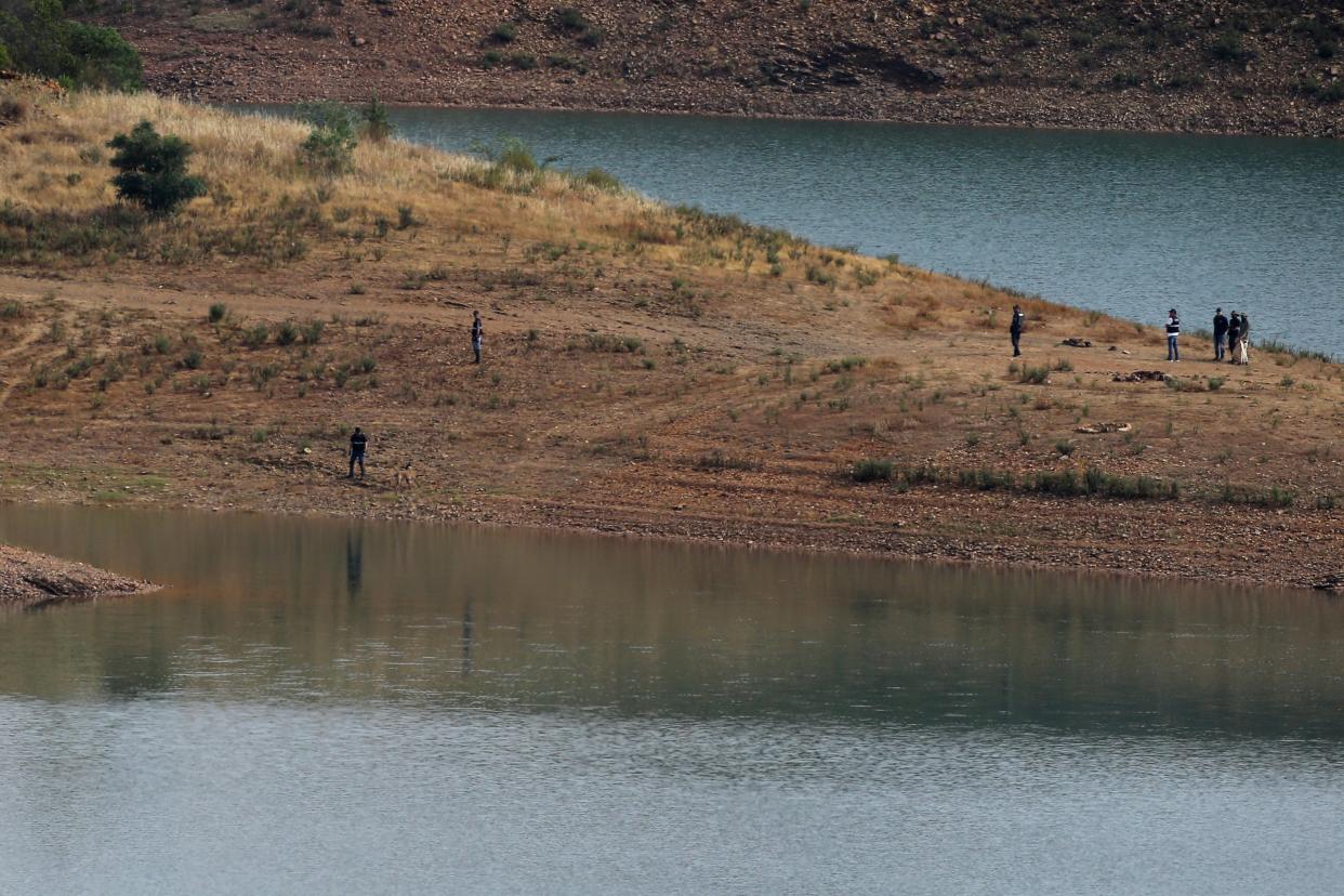 Police work on the banks of the Arade dam near Silves, Portugal (AP)