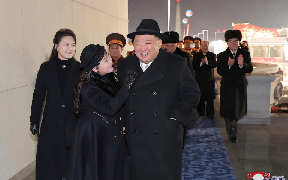 Kim Jong Un with his daughter and his wife Ri Sol Ju, left, attend the military parade in Pyongyang - KCNA via KNS/AP