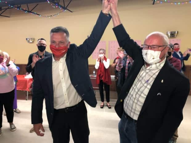 Heath MacDonald, left, celebrates with Wayne Easter, the Liberal MP who had represented Malpeque since 1993. (Brian Higgins/CBC - image credit)