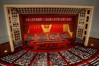 Officials and delegates attend the opening session of NPC in Beijing