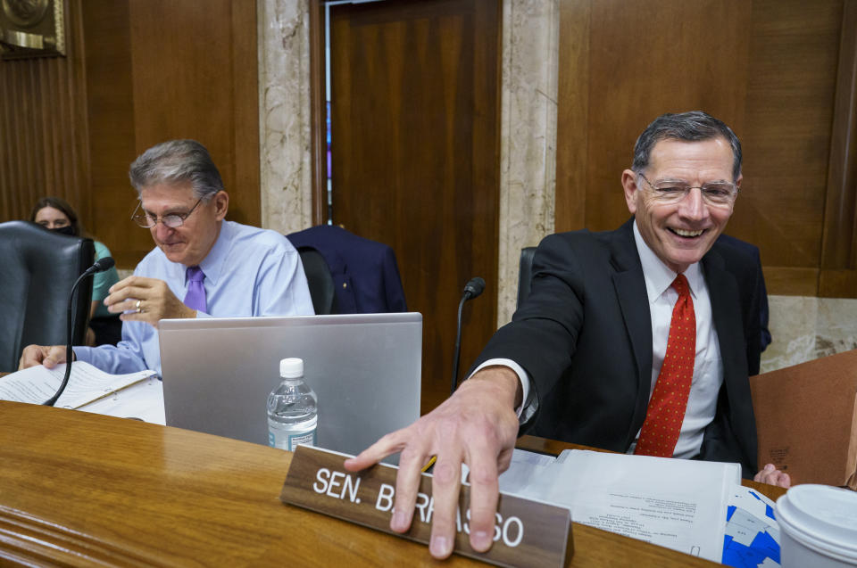 Sen. Joe Manchin, D-W.Va., left, chair of the Senate Energy and Natural Resources Committee, is joined by Sen. John Barrasso, R-Wyo., the ranking member, at the Capitol in Washington, Thursday, Aug. 5, 2021. Lawmakers continue to work today to advance the $1 trillion bipartisan bill which includes new expenditures on roads, bridges, water pipes broadband and other projects, plus cyber security. (AP Photo/J. Scott Applewhite)