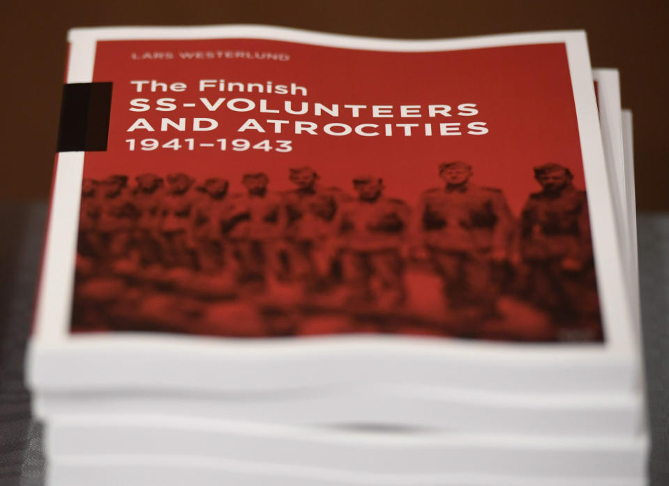 The research document entitled The Finnish SS-volunteers and atrocities 1941 - 1943 against Jews, detailing atrocities against civilians and Prisoners of War in Ukraine and the Caucasus Region, pictured in Helsinki, Finland, on Friday Feb. 8, 2019. Senior Israeli Holocaust historian, Efraim Zuroff of the Simon Wiesenthal Center, on Sunday Feb. 10, 2019, has praised Finnish authorities for publishing a report concluding that the Nordic country's volunteer battalion serving with Nazi Germany's notorious Waffen-SS took part in atrocities during World War II including participating in the mass murder of Jews.(Heikki Saukkomaa/Lehtikuva via AP)