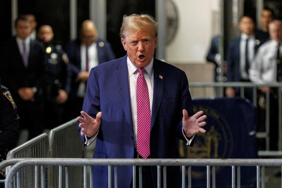 Donald Trump speaks to the press before court on 19 April (via REUTERS)