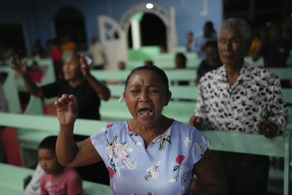 A congregant sings during a church service in Chinese Landing, Guyana, Sunday, April 16, 2023. Guyana has some 78,500 Amerindians who represent nearly 10% of the country’s population. They live in more than 240 communities that often are home to large deposits of gold like Chinese Landing. (AP Photo/Matias Delacroix)