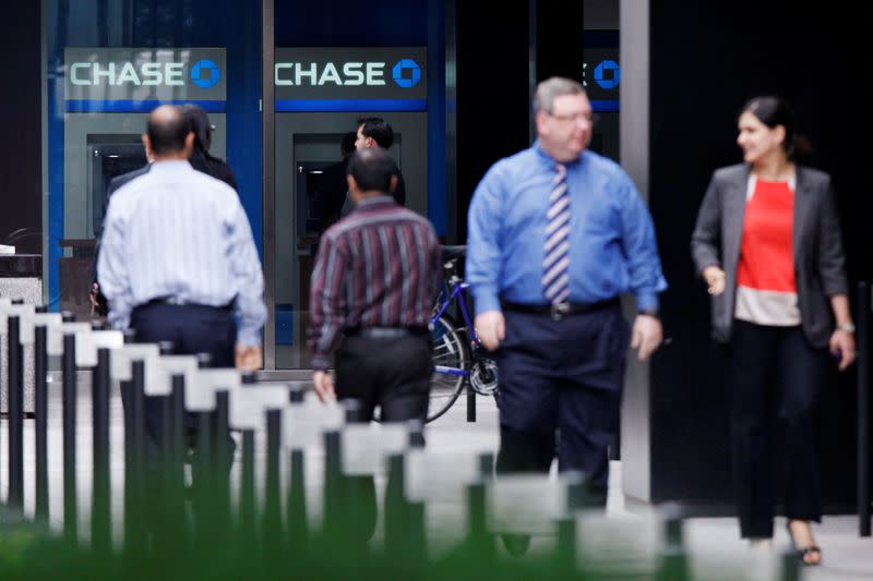 FILE PHOTO: People walk next to JPMorgan Chase & Co. headquarters in New York