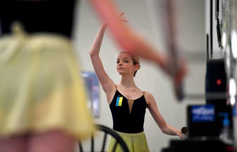 Lilly Wheeler wears the colors of Ukraine, blue and yellow, on her leotard and pinned to her hair as she trains at The International Ballet of Florida in University Park on March 3, 2022. The owners of the school quickly changed the name from The School of Russian Ballet in reaction to Russia’s invasion of Ukraine.