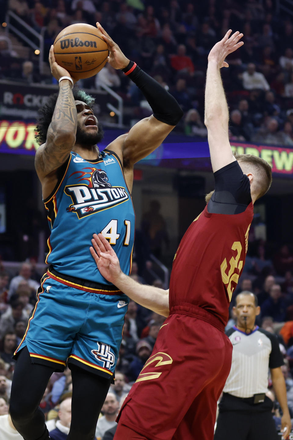 Detroit Pistons forward Saddiq Bey (41) shoots against Cleveland Cavaliers forward Dean Wade (32) during the first half of an NBA basketball game, Wednesday, Feb. 8, 2023, in Cleveland. (AP Photo/Ron Schwane)